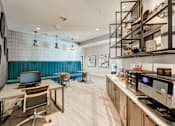 Thumbnail 19 of 33 - A modern kitchen with a blue backsplash and wooden floors.