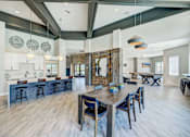 Thumbnail 18 of 33 - A modern kitchen with a bar and dining area.