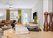 Thumbnail 5 of 48 - A modern dining room with a wooden table set for two.
