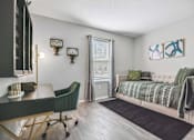 Thumbnail 9 of 48 - A bedroom with a bed, chair, and desk.