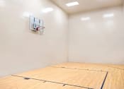 Thumbnail 12 of 20 - A basketball court with a hoop on the wall.