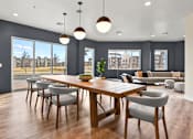 Thumbnail 19 of 30 - A modern dining room with a large table and chairs.
