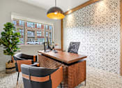 Thumbnail 24 of 30 - A modern office with a wooden desk and two chairs.