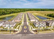 Thumbnail 6 of 26 - A suburban neighborhood with a roundabout in the center.