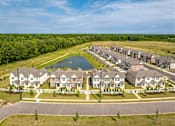 Thumbnail 8 of 26 - A row of houses with a lake in the middle.