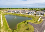 Thumbnail 9 of 26 - A residential area with a lake and houses.