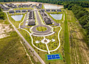 Thumbnail 17 of 26 - A bird's eye view of a housing development with a central park area.