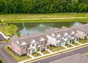 Thumbnail 19 of 26 - A row of houses with a pond in the front yard.