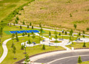 Thumbnail 23 of 26 - A park with a blue pool and a winding road.