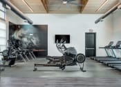 Thumbnail 16 of 26 - a gym with cardio machines and art on the wall