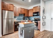 Thumbnail 3 of 26 - a kitchen with stainless steel appliances and wooden cabinets