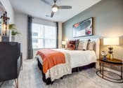 Thumbnail 6 of 26 - a bedroom with a bed and a ceiling fan