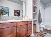 Thumbnail 9 of 26 - a bathroom with wooden cabinets and a toilet and a shower