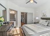 Thumbnail 8 of 34 - A bedroom with a large bed and a ceiling fan.