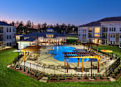 Thumbnail 29 of 29 - A large swimming pool surrounded by a fence and a gazebo in the middle of a grassy area.