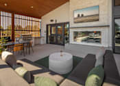 Thumbnail 29 of 34 - A living room with a couch, a table, and a painting on the wall.