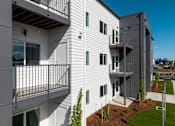 Thumbnail 27 of 27 - Modern apartment building with white siding and balconies at The Arvon, WA 98662
