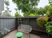 Thumbnail 27 of 56 - a small patio with a chair and a privacy fence