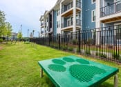 Thumbnail 11 of 29 - a green ping pong table in front of an apartment building