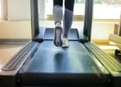 Thumbnail 39 of 59 - a woman running on a treadmill in a gym