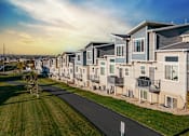 Thumbnail 19 of 21 - A row of modern houses with a pathway in front.