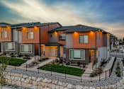 Thumbnail 21 of 26 - A row of modern houses with a gravel pathway in front.