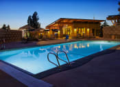 Thumbnail 9 of 43 - a swimming pool in front of a hotel at dusk