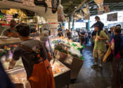 Thumbnail 16 of 18 - people standing in line at a fish market