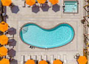 Thumbnail 19 of 34 - A large swimming pool surrounded by orange umbrellas.
