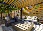 Thumbnail 30 of 38 - a patio with a couch and chairs and a coffee table