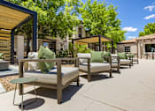 Thumbnail 16 of 38 - an outdoor patio with chairs and tables and a fire pit