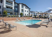 Thumbnail 12 of 23 - Pool on sunny day with lounge chairs