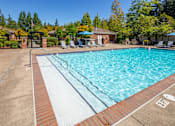 Thumbnail 22 of 34 - A swimming pool with a brick edge and a white inner lining.