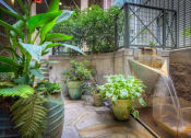 Thumbnail 11 of 18 - a water feature with a waterfall and a variety of plants on a patio