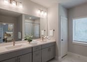 Thumbnail 18 of 31 - a white bathroom with two sinks and a large mirror
