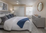 Thumbnail 14 of 28 - a bedroom with a large bed and a dresser