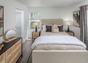 Thumbnail 3 of 23 - A bedroom with a large bed and a wooden dresser.
