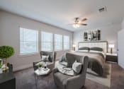Thumbnail 8 of 31 - a bedroom with a large bed and a ceiling fan