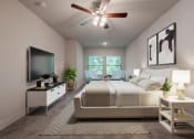 Thumbnail 4 of 31 - a bedroom with a large bed and a ceiling fan