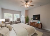 Thumbnail 22 of 31 - a bedroom with a large bed and a ceiling fan