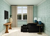 Thumbnail 25 of 26 - A living room with a black sofa, a wooden table, and two blue lamps.