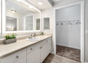 Thumbnail 8 of 25 - A bathroom with a white sink and a large mirror.