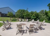 Thumbnail 27 of 31 - a patio with chairs and a fire pit