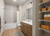 Thumbnail 53 of 68 - A bathroom with a white tub, toilet, and sink.