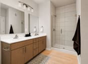 Thumbnail 52 of 68 - A bathroom with a double sink vanity and a walk in shower.