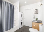 Thumbnail 6 of 16 - Bathroom with a washing machine and a toilet