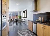 Thumbnail 2 of 16 - Kitchen and dining area with a table and chairs and a large window