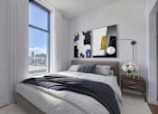 Thumbnail 15 of 30 - Bedroom with city view, queen sized bed, and decor