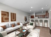 Thumbnail 5 of 50 - A modern living room with a white sofa, a coffee table, and a kitchen area in the background.