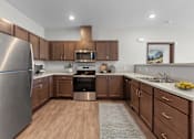 Thumbnail 2 of 50 - A modern kitchen with wooden cabinets and stainless steel appliances.
